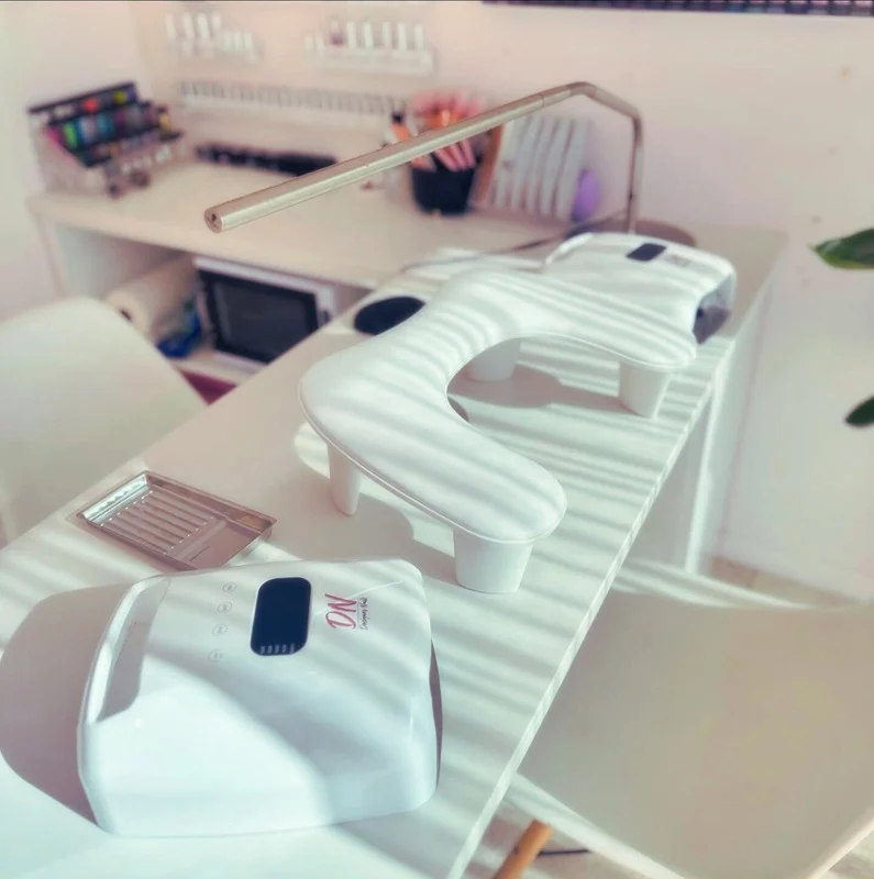 Clean white Nail Alley workstation with Designer Nails UV lamps